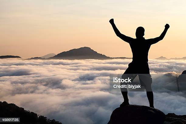 Man Hiking Climbing Silhouette In Mountains Stock Photo - Download Image Now - Arms Outstretched, Cloud - Sky, Men
