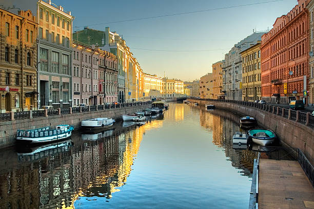Moyka river in St.Petersburg View at Pevchesky Bridge through Moyka river with boats in Saint-Petersburg. Spring st petersburg river stock pictures, royalty-free photos & images