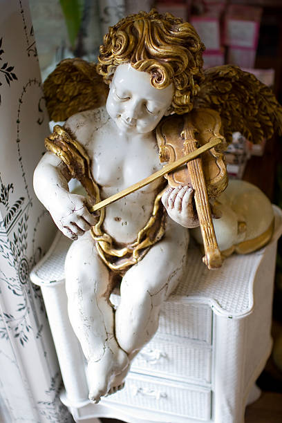 Statue of children playing music Antique, Old-fashioned, Angel, Figurine, Yellow, Statue, Child,White, Cheerful, Musician, Season, Decoration, Symbol, Christmas, Arts And Entertainment, Isolated Objects, Arts Symbols, Spirituality, Classical Style, Religion, Artificial Wing, Symbols Of Peace, Christmas Decoration, Single Object, Celebration, Heaven, Ornate, Gold, Cupid, Cherub, Sculpture, Standing, Christianity, Objects with Clipping Paths winged cherub stock pictures, royalty-free photos & images