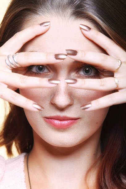 Close up, Young woman showing a pill between her fingers