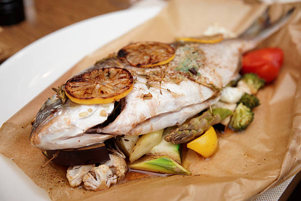 istock Gilt-head bream roasted in paper with vegetables 450029219