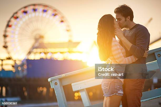 Romantic Couple Kissing At Sunset Stock Photo - Download Image Now - Amusement Park, Couple - Relationship, Kissing