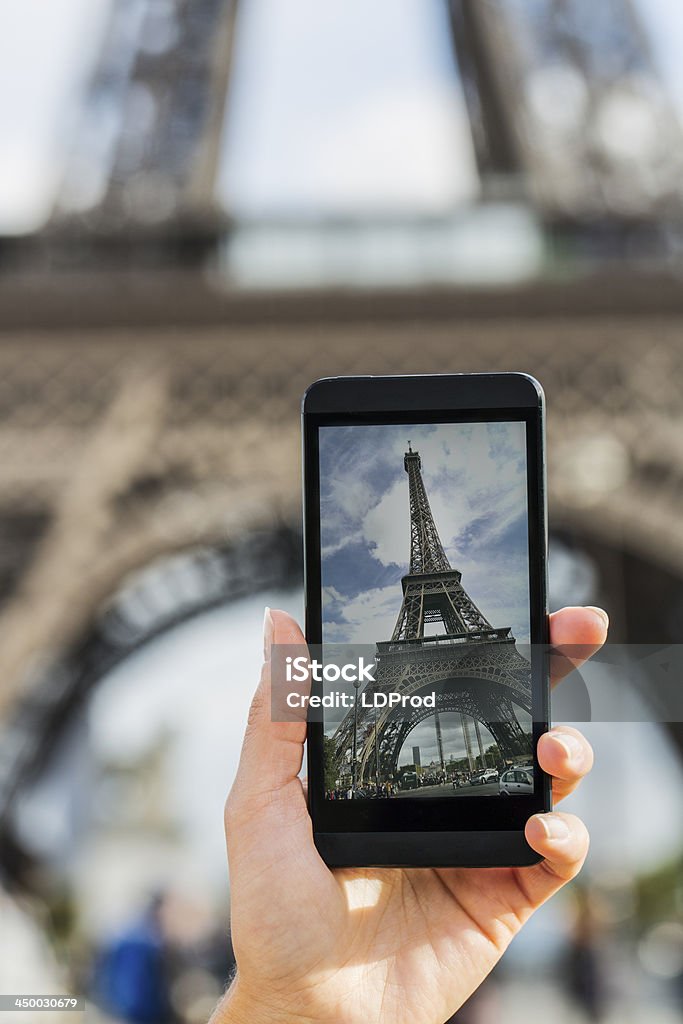 Taking a picture of Eiffel Tower in Paris with a smartphone Female smart phone photography travel France summer Adult Stock Photo