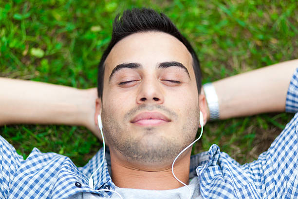 istock Young man listening to music 450033315