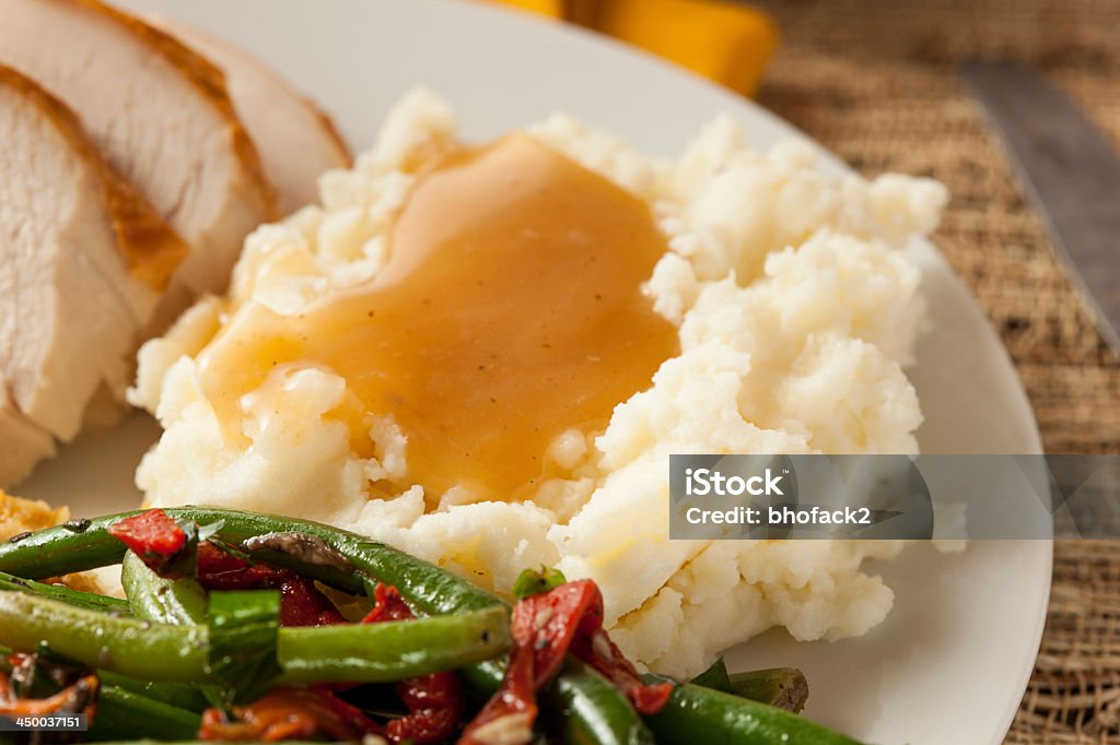 Mash potato and gravy with green beans and turkey slices Homemade Organic Mashed Potatoes with Gravy for Thanksgiving Gravy Stock Photo