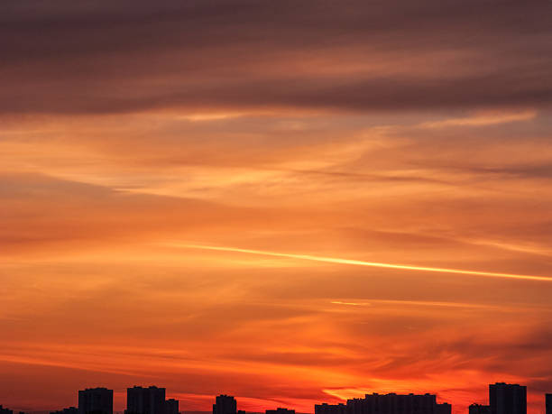 istock Bright sunset over dark skyline with multicolored evening glow 450038361