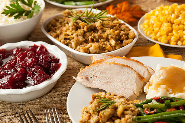 istock Thanksgiving dinner showing turkey cranberry sauce and other 450039323