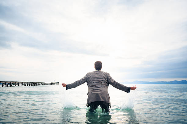 istock businessman knee-deep in water 450039877
