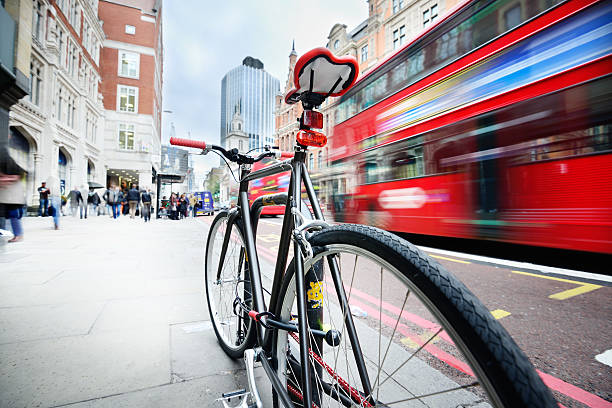 Parked bike on sidewalk in the city. Motion blurred bus and pedestrians.