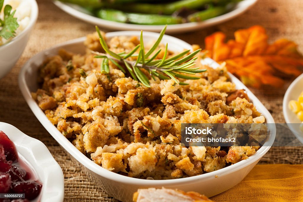 Homemade thanksgiving stuffing in a white bowl Homemade Thanksgiving Stuffing Made with Bread and Herbs Stuffing - Food Stock Photo