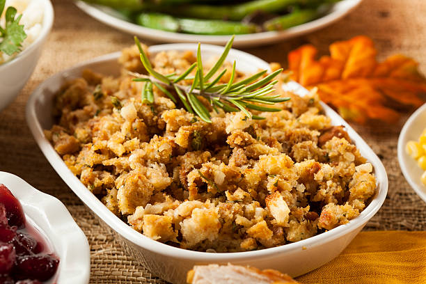 Homemade thanksgiving stuffing in a white bowl Homemade Thanksgiving Stuffing Made with Bread and Herbs filling photos stock pictures, royalty-free photos & images