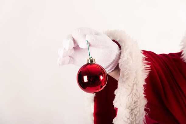 istock Santa Claus' hand holds a Christmas ball 450055731