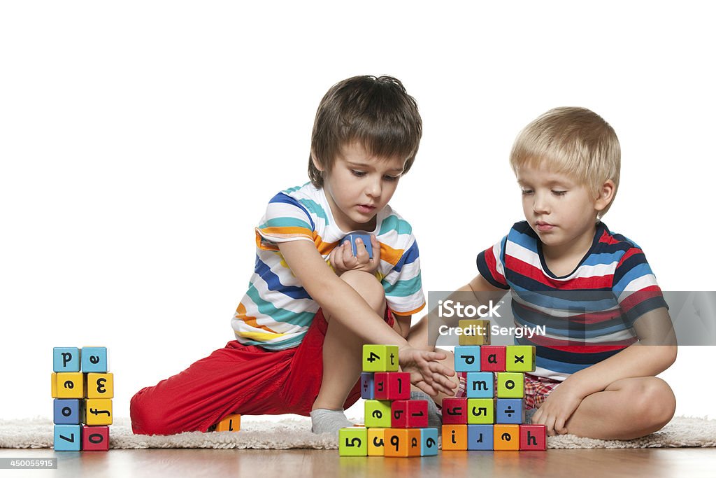 Two boys with blocks Two cute boys are playing with blocks on the floor 2-3 Years Stock Photo