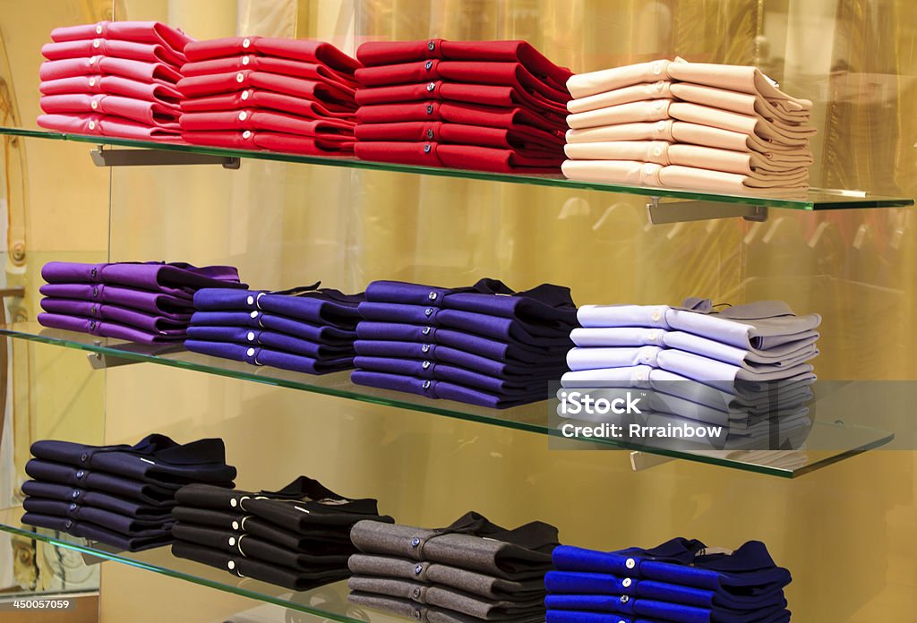 Folded clothes in the department store Folded clothes on shelves in the department store Blue Stock Photo