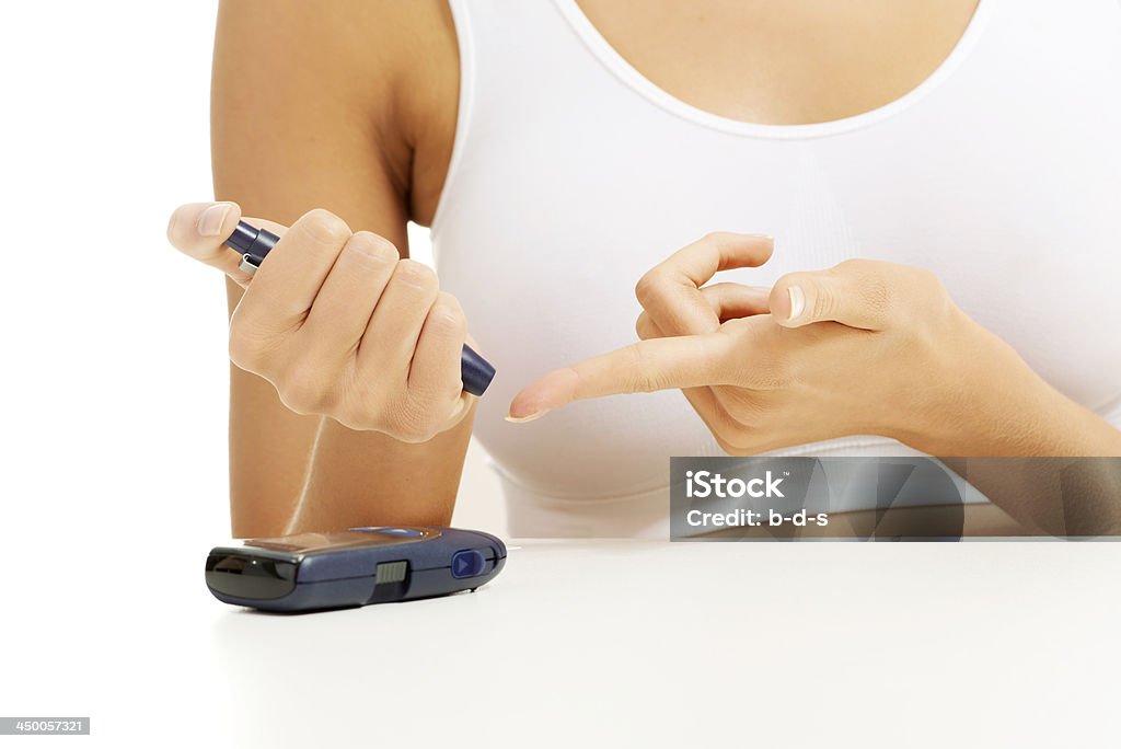 Diabetes patient measuring glucose level blood test with glucometer. Diabetes patient woman measuring glucose level blood test with glucose meter on a white background Blood Stock Photo