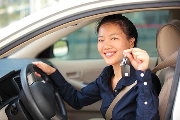 istock woman driver happy with her first car 450060777