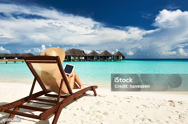 Young Lady Relaxing On Beach Lounger With Her Tablet Stock Photo - Download Image Now