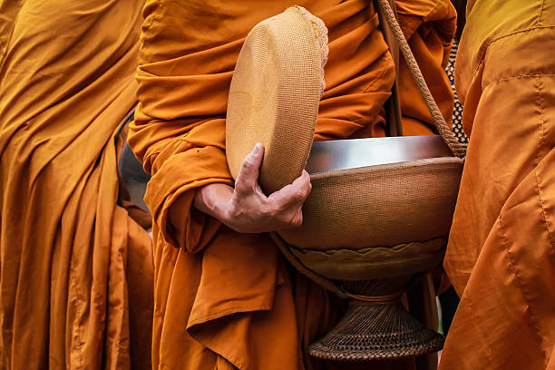 istock Giving to aims of thai monks. 450066911