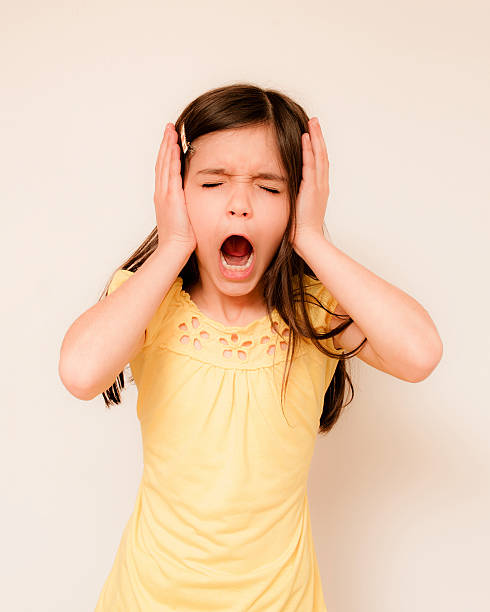istock Little girl covering her ears 450068109
