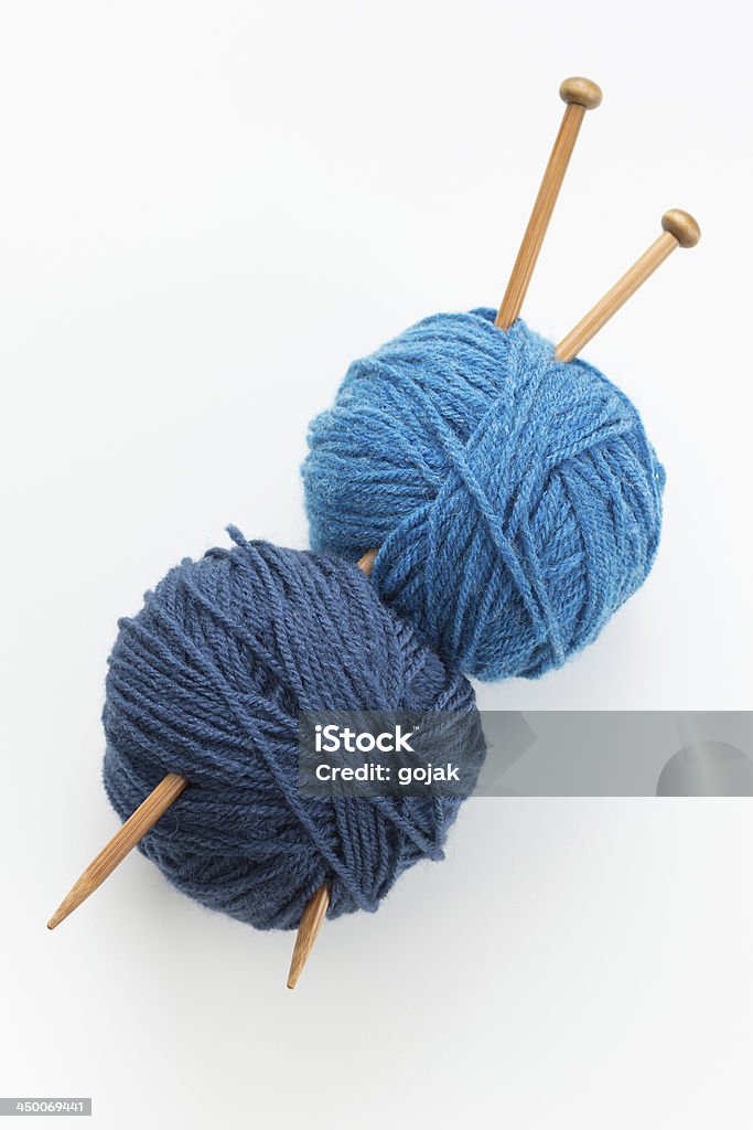 Knitting Knitting yarn balls in blue tone and needles Ball Of Wool Stock Photo