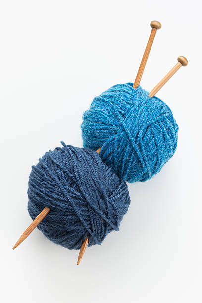 Knitting Knitting yarn balls in blue tone and needles knitting needle stock pictures, royalty-free photos & images