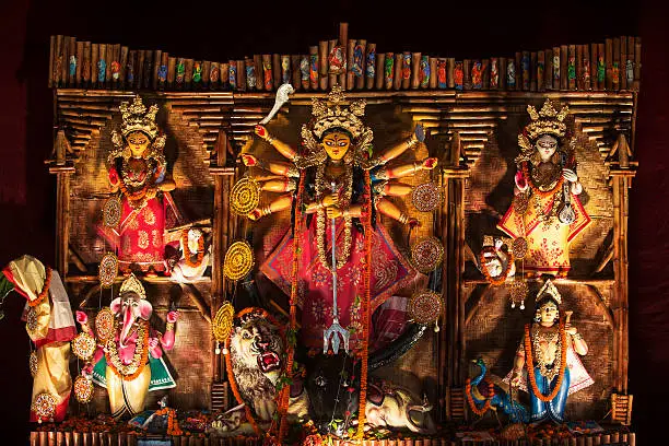 An Indian Deity : Goddess Durga. The deity made out of clay is adorned with decorative work. The worship during this "Durga Puja Festival" takes place in a temporary shed made out of canvas and bamboo, and is decoarated with colourful cloth.