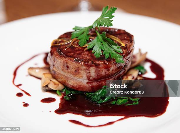 Tenderloin Steak Wrapped In Bacon With Red Sauce And Garlic Stock Photo - Download Image Now