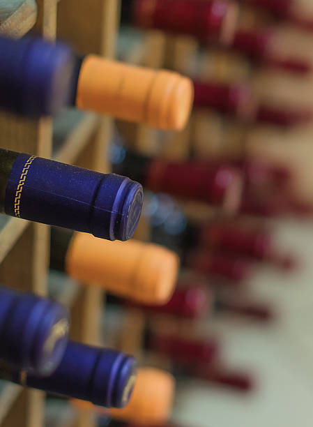 istock Different wine bottles stacked on wooden racks 450076297
