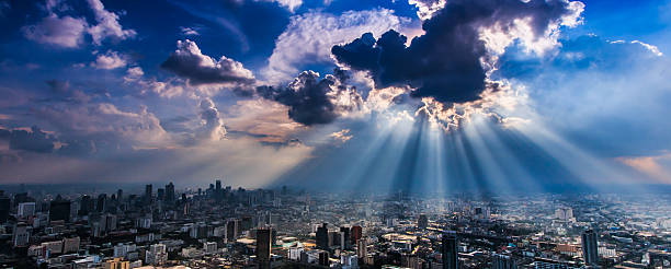 istock Rays of light shining through dark clouds city Bangkok, Thailand 450085013