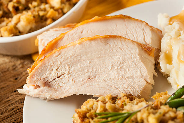 Sliced roasted turkey breast with herbs and salad