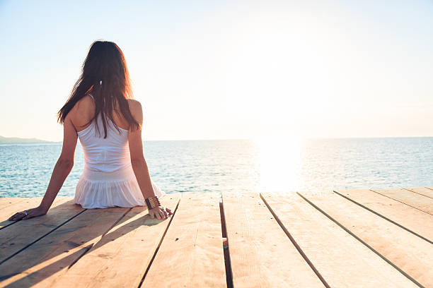 istock young woman by the sea 450087803