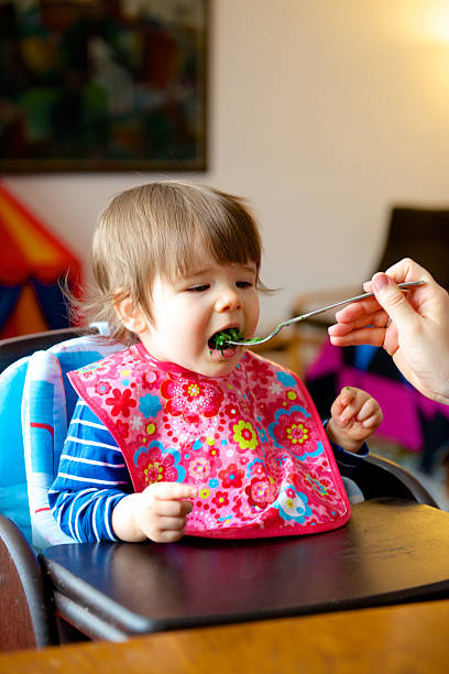 Toddler being fed