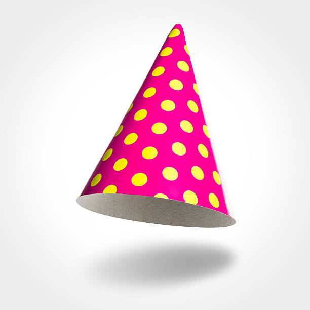 Pink party hat in the air with yellow spots isolated on white background, vignetting, shadow. Studio shot.