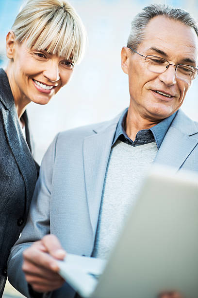 istock Two business people working on laptop. 450107713