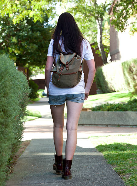 istock teenager walking to school 450112097