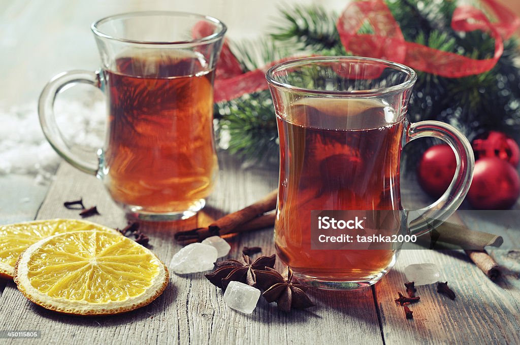 Mulled wine with spices Mulled wine with spices and christmas decoration on wooden background Alcohol - Drink Stock Photo