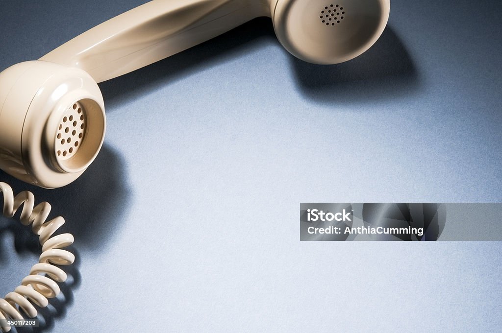 Cropped Telephone receiver and cord with copy space Communication Concept - Retro telephone lying off the hook with copy space Phone Cord Stock Photo