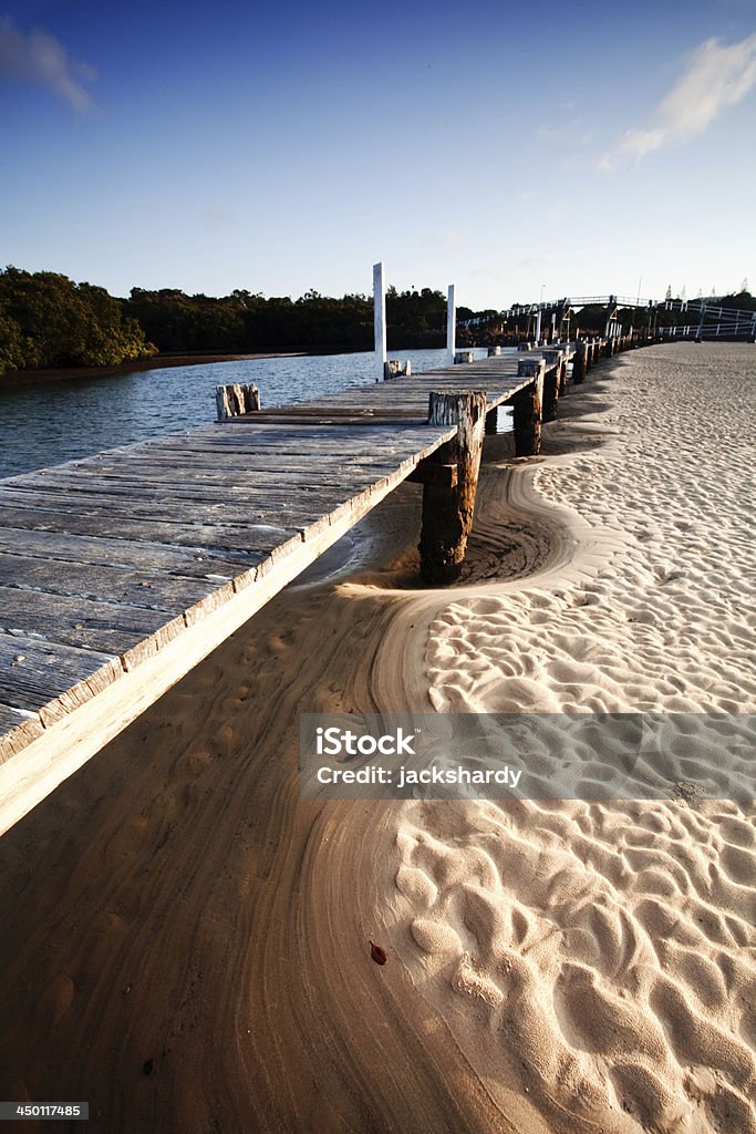 The Boardwalk An old timber boardwalk stretches along a sandbank in the estuary of a coastal inlet Boardwalk Stock Photo