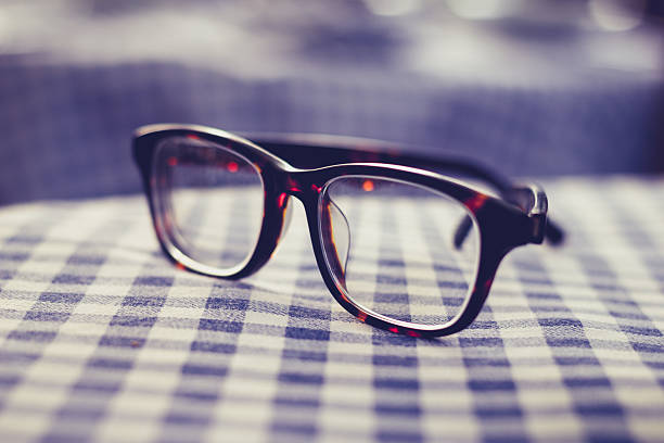 istock Pair of glasses on a checkered table cloth 450141157