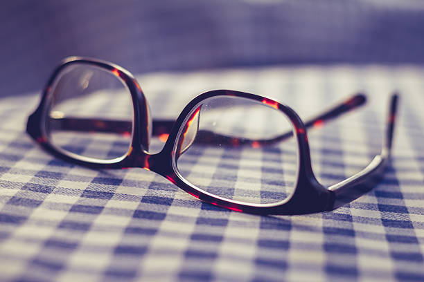 istock Pair of glasses on a checkered table cloth 450142759