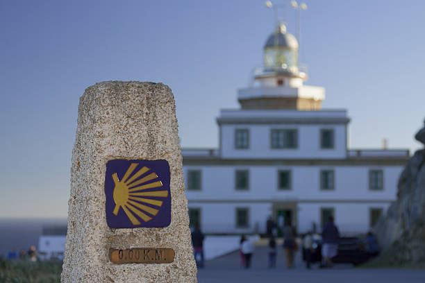 Spain, Galicia, Fisterra, milestone, kilometer zero of Camino de Santiago, lighthouse in the background