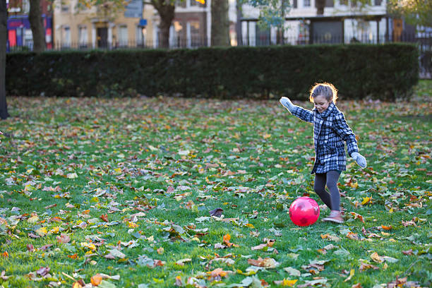 istock Little girl playing with a red ball 450151465