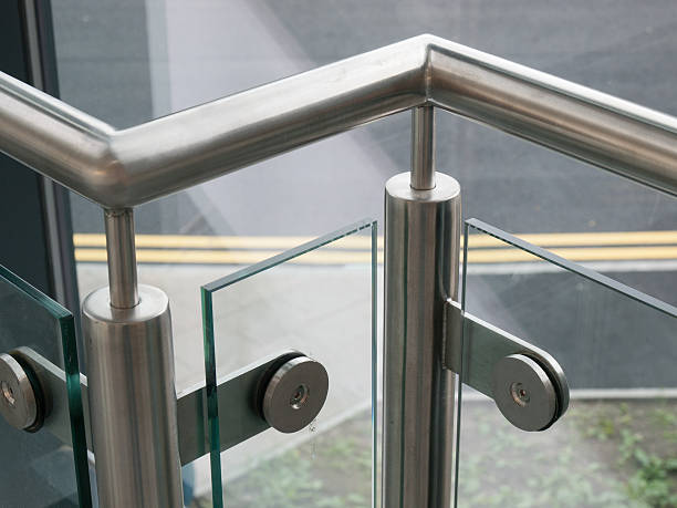 Sturdy silver metal handrail with glass in between stock photo