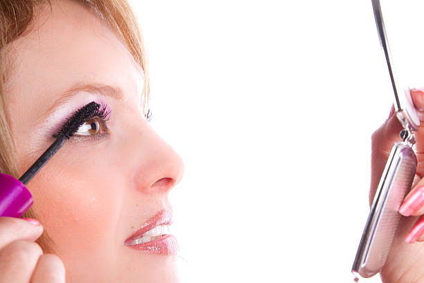 istock Woman applying mascara on her long eyelashes 450152779