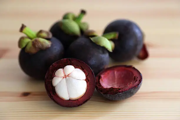 Group of Mangosteen on Wooden Table