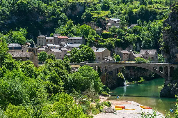 Gorges du Tarn (Lozere, Linguedoc-Roussillon, France), famous canyon at summer. Village, bridge and canoes