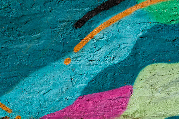 bunt bemalte wand - textured textured effect graffiti paint stock-fotos und bilder