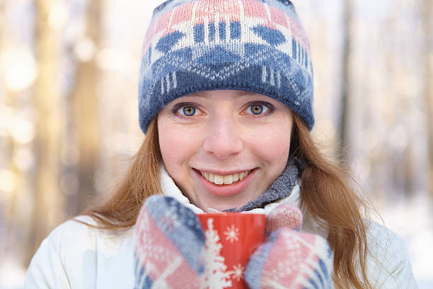 istock Outdoors on a winter day. Young woman drinks tea. 450177643