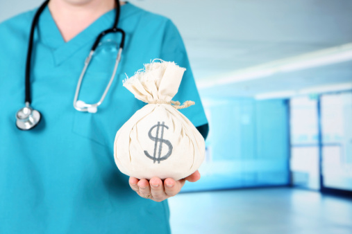 Nurse in hospital holding moneybag