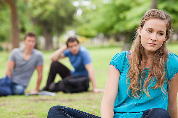 istock Close up of a sad student sitting on the grass 450208113